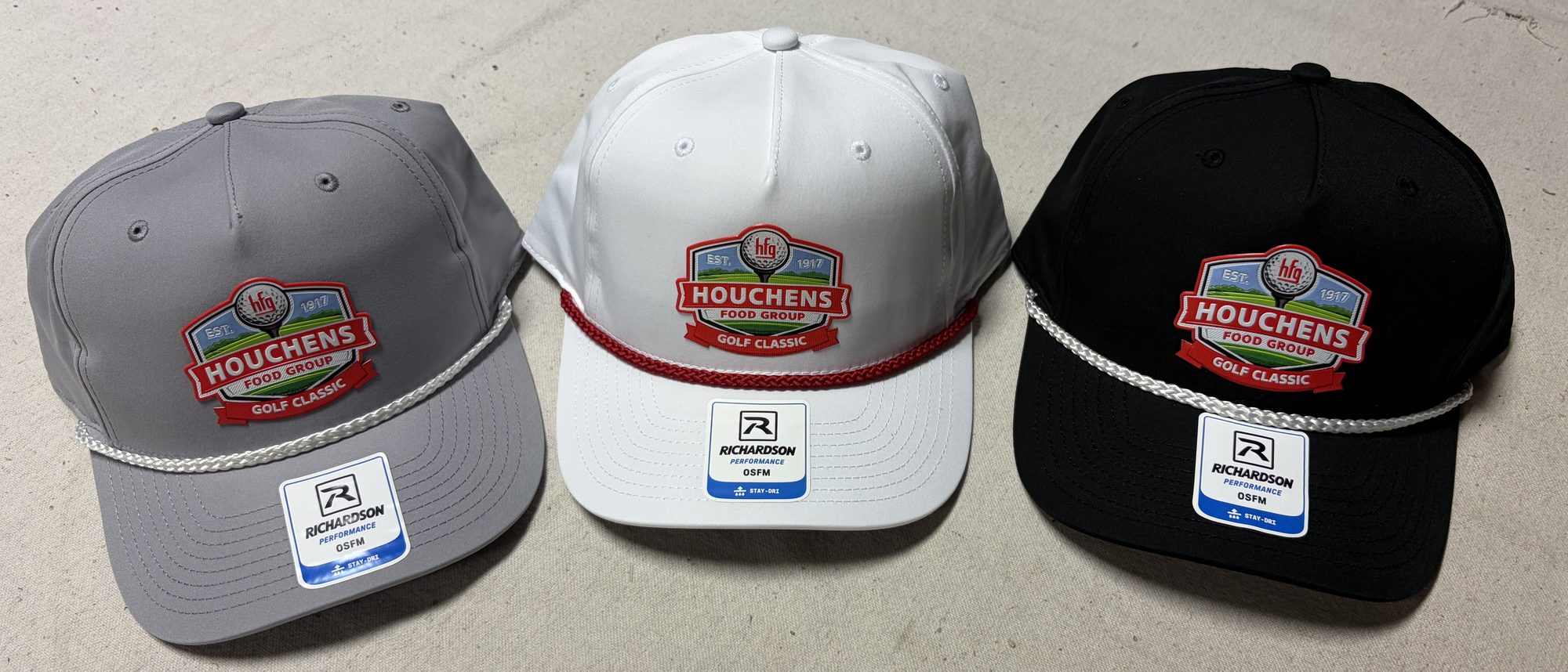Three rope caps in event colors for a golf tournament